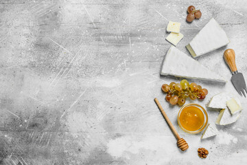 Fototapeta premium Brie cheese with honey and grapes.