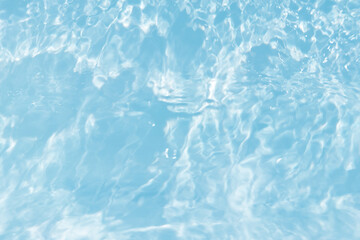Defocus blurred transparent blue colored clear calm water surface texture with splashes and bubbles. Trendy abstract nature background. Water waves in sunlight with caustics. Blue water shinning 
