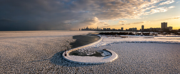 Beautiful Chicago skyline aerial drone view from above the frozen ice and snow covering Lake...