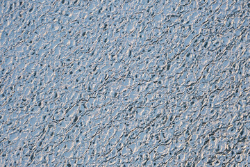Top down aerial view of circular or rounded ice chunks covered in snow floating on the cold waters of Lake Michigan creating a fantastic textured winter  background with copy space.
