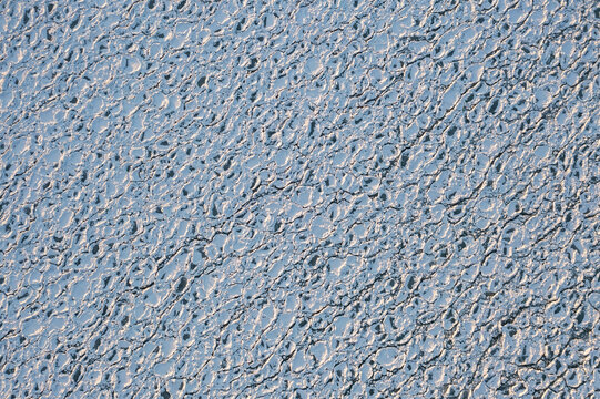 Top down aerial view of circular or rounded ice chunks covered in snow floating on the cold waters of Lake Michigan creating a fantastic textured winter  background with copy space. - Powered by Adobe