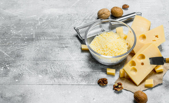 Grated cheese in a bowl with walnuts.