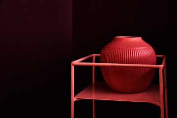 Abstract geometric shape in red, minimalistic stage with podium and vase. Design for a branded product with copy space. High quality photo