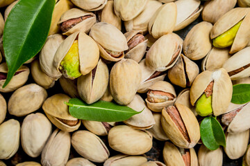 Pistachios with leaves texture .
