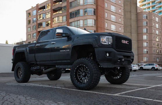 GMC Denali truck parked on a street. Black truck at the city.