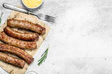 Grill beef sausage with sauce .