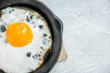 Fried egg in a frying pan.