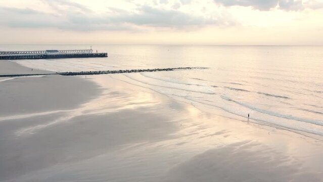 Beautiful White beach with reflecting sea in sunset with sober colors, in Blankenberge, belgium
