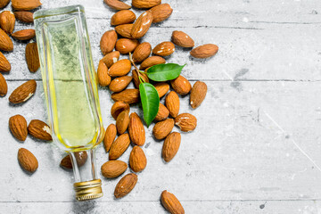 Almond oil in a glass bottle .
