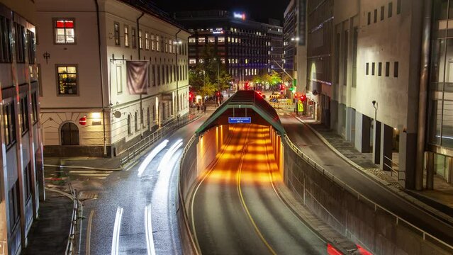 Busy night traffic in the center of Oslo timelapse tunnel entrance
