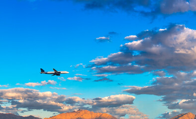 Airplane flying over the mountains and clouds