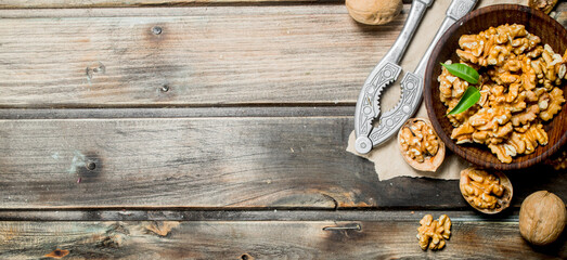 Fototapeta na wymiar Shelled walnuts with a Nutcracker.