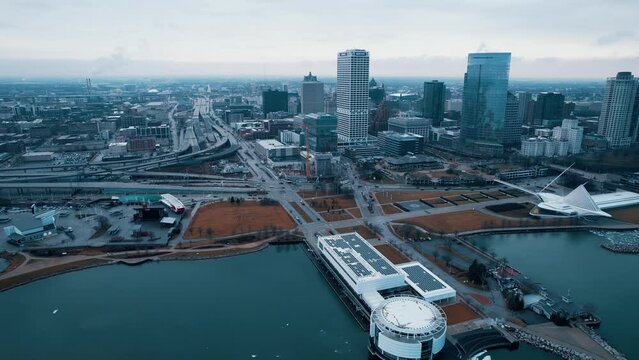 Pleasing Aerial Featuring Milwaukee Wisconsin Downtown Skyscrapers, Discovery World, Art Museum, Daniel Hoan Memorial Bridge, Construction Crane. Perspective From Lake Michigan. Sunrise