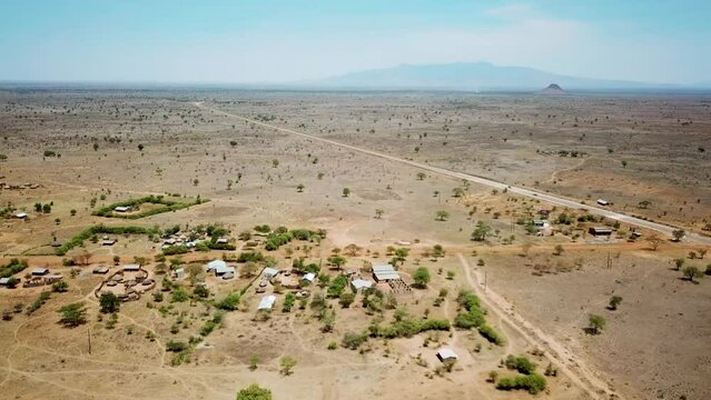 Aerial view zooming out from a village of Karamoja, also known as Manyatta or Ere, on a sunny day in Uganda, Africa. High quality 4k footage