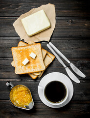 Breakfast. Toasted bread with butter, coffee and orange jam.