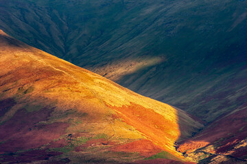 Fototapeta na wymiar Dramatic light in the sheep doted Connemara hills