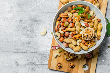 Different kinds of nuts in bowl .