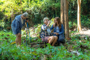 Naklejka na ściany i meble Group of backpackers go on an adventure in the jungle together.