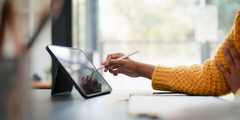 Young black curly hair American African woman using digital tablet