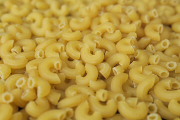 background and texture of pile of raw macaroni