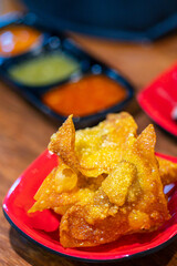 fried dumplings on red plate in restaurant.