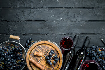 Wine background. Red wine with grapes and an old barrel.