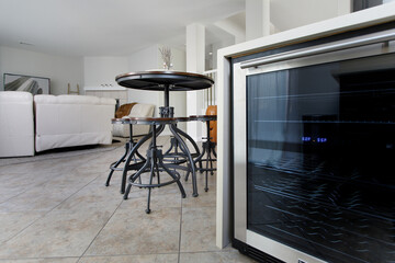 A view of a wine refrigerator in a home living room setting.