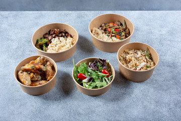 A view of several sizes of paper to-go food containers.
