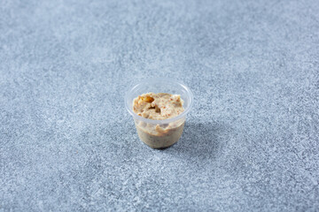 A view of a condiment cup of whole ground mustard.