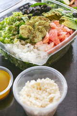 A view of a garden salad inside a clamshell plastic container.
