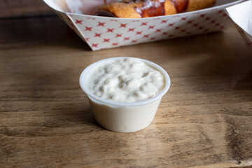 A view of a condiment cup of cottage cheese.