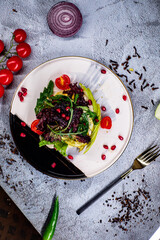 salad with apple, quinoa, pomegranate, cucumbers, cherry and lemon