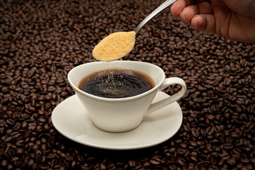 Cup of coffee on brown coffee beans