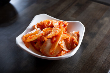 A view of condiment cup of kimchi.