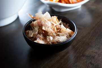 A view of a condiment cup of katsuobushi, or bonito flakes.