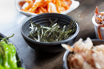 A view of a bowl of shredded nori topping.