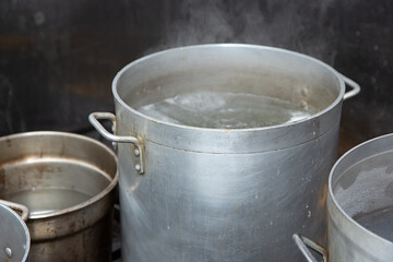 Fototapeta premium A view of several large stockpots in a restaurant kitchen setting.