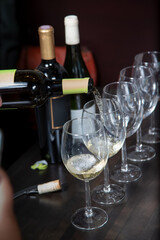 A view of a white wine pouring into wine glasses.