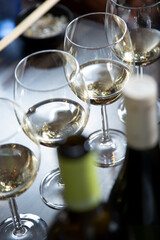A view of a row of wine glasses featuring white wine.