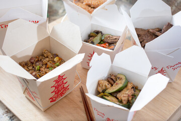 A view of several open Chinese food take out containers.
