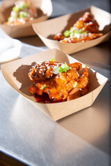 A view of a tray of some garnished buffalo chicken wings.