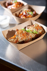A view of three orders seasoned chicken wings.