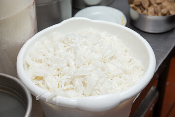 A view of a large bowl of freshly made vermicelli noodles, used for Vietnamese pho.