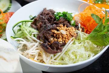 A view of a bowl of Vietnamese bun with marinated beef.