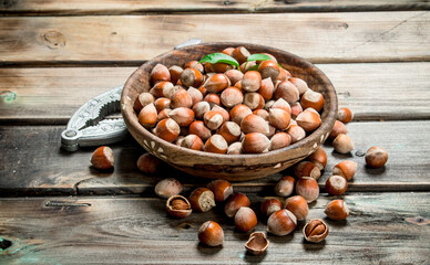 Hazelnuts in a bowl with a Nutcracker.