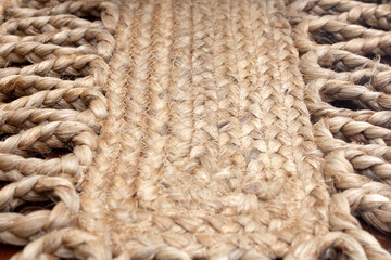 A closeup view of a woven burlap straw table runner, as a background.