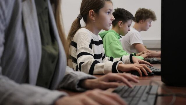 Schoolgirl using computer during computer sciene lesson in school.