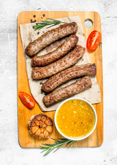 Grill sausages with sauce on the Board .