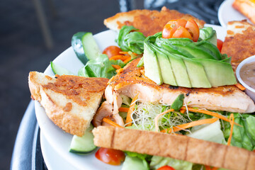A closeup view of a salmon avocado salad.
