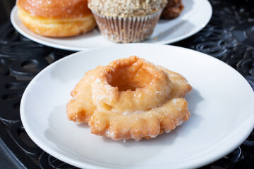 A view of an old-fashioned donut on a plate.